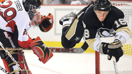 The Penguins' Marian Hossa flys through the air past Senators' goalie Martin Gerber in the third period of Game Two last night at Mellon Arena.