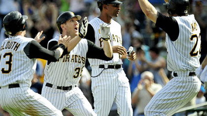 Nate McLouth, Jason Bay and Xavier Nady celebrate Sunday after Bay hit the winning single to score Chris Gomez in the bottom of the 11th inning to beat the Chicago Cubs 6-5 at PNC Park.