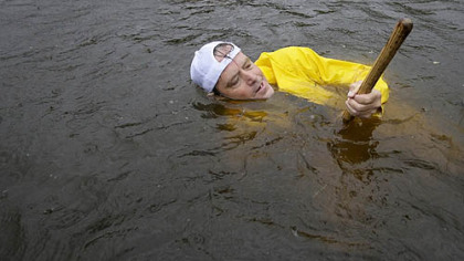 HOUSTON -- Greg Schneck works to clear a sewer drain as floodwaters from Hurricane Ike rise near his business Saturday.