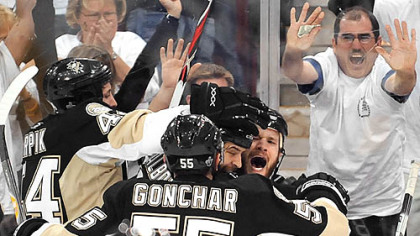 The Penguins' Adam Hall (right  with mouth open) is mobbed by teammates after scoring in the third period.