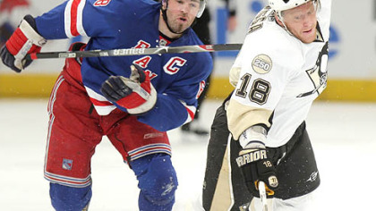 Rangers' Jaromir Jagr, left, trips up Penguins'Marian Hossa,in the first period during Game 3 of an NHL Eastern Conference semifinal hockey playoff game Tuesday.