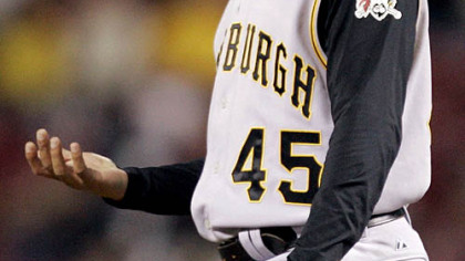 Pirates pitcher Ian Snell looks at his pitching hand as he waits to be taken out in the sixth inning against the Cincinnati Reds last night.