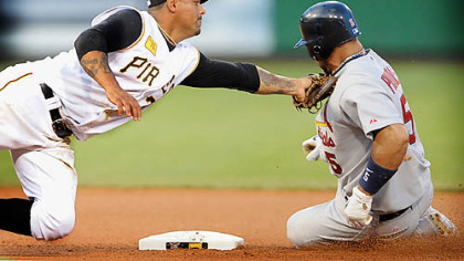Umpire Eric Cooper called Pujois safe after Pirates second baseman Luis Rivas tags Cardinals Albert Pujois.