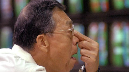 TAIPEI -- An investor looks at the monitors showing falling share prices at a stock trading house Tuesday, Oct. 7. Taiwan share prices closed up 18.96 points, or 0.34 percent, at 5,524.66 points on October 7, recovering from earlier losses due to likely government support after October 6 global market slump, dealers said.