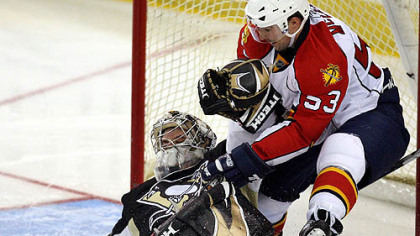 Ty Conklin makes one of his 35 saves against Florida's Brett McLean yesterday at Mellon Arena. Conklin went on to shut out the Panthers, 3-0, for the team's sixth consecutive victory.