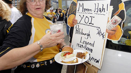 Steelers' fan Barbara Cord, of Baldwin Borough, outside Heinz Field on Sunday, is a veteran tailgater, having begun her "career" in 1959 when the team played at Pitt Stadium. Her friends says she makes the best haluska. The Myron Cope cardboard standup belongs to friend.