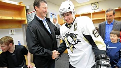 Owner Mario Lemieux, left, worked his way through the victorious Penguins locker room in the moments after they completed their sweep of the Senators last night in Ottawa == the Penguins' first series victory since 2001.