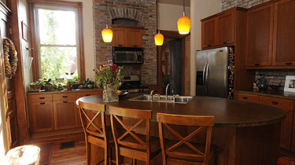 The kitchen's defining feature is a large island with a concrete countertop