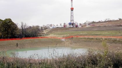 A drilling rig used to bore thousands of feet into the earth to extract natural gas from the Marcellus 
Shales deep underground is seen on the hill above the pond on John Dunn's farm in Houston, Pa., in October.