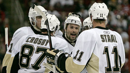 Penguins winger Petr Sykora, center, celebrates one of his two goals against the Hurricanes last night in Raleigh, N.C.