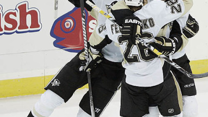 Ruslan Fedotenko is congratulated by teammates Evgeni Malkin, left, and Petr Sykora, right, after making a goal against the New Jersey Devils in the second period.