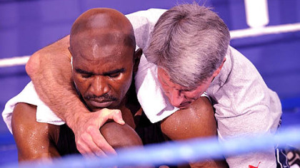 ZURICH -- American Evander Holyfield streches with his trainer, Thomas Brook, during a public training, Dec.15. World Boxing Association heavyweight champion Nikolai Valuev, from Russia, will defend his title against Holyfield, Dec. 20.