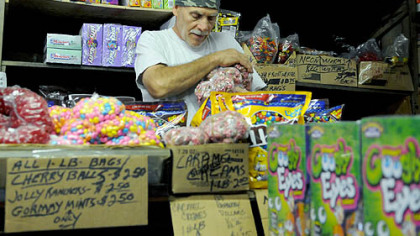 Vincent Ionadi of East Liberty, stocks the shelves  at the Fort Pitt Candy Company in the Strip.