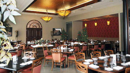 The main dining room of Cioppino in the Strip District is filled with lots of warm brown wood and rustic arrangements of natural materials.