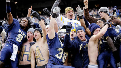 Pitt's T.J. Porter, left, and Mike Toerper jump into the stands after defeating West Virginia, 19-15, in the Backyard Brawl yesterday at Heinz Field.