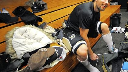 Penguins winger Petr Sykora sits next to hats that were thrown on the ice after his hat trick against the Islanders last night at the Mellon Arena.