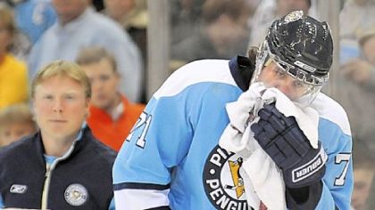 Evgeni Malkin skates off the ice after taking a stick to the mouth in play against The Wild in the second period at the Mellon Arena, last night.