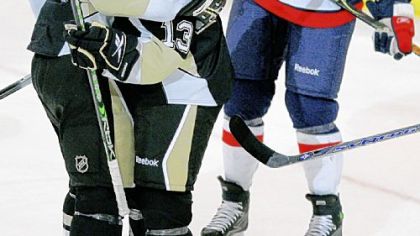 Alex Goligoski, center, celebrates a goal against Washington with teammate Jordan Staal == his second NHL goal.