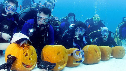 KEY LARGO, Fla. -- In this photo released by the Florida Keys News Bureau, most of the participants in the Underwater Pumpkin Carving Contest display their entries in the Florida Keys National Marine Sanctuary off Key Largo, Fla. Entrants worked in teams of two and competed for dive-related retail merchandise prizes.