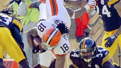 Steelers linebacker Andre Frazier upends Cleveland's Donte' Stallworth in the first quarter.