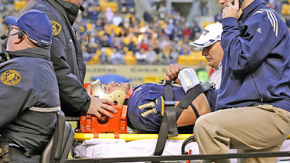 Pitt quarterback Bill Stull is tended to by trainers and emergency personnel after being injured in the third quarter of yesterday's game against Rutgers at Heinz Field.