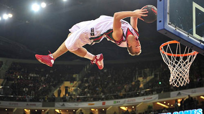 BEIJING -- A member of the Milwaukee Bucks "Rim Rockers" goes airborne for an acrobatic  slam dunk during a break in the game against the Golden State Warriors at an NBA preseason exhibition game.