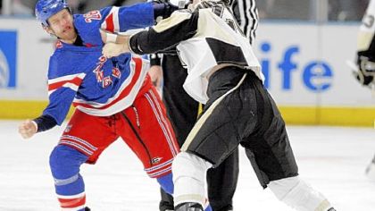 New York's Colton Orr, left, and Eric Godard squared off early in last night's game.