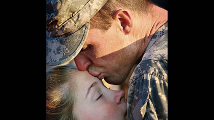 DYERSBURG, Tenn. -- Frank Cheatham kisses his daughter, Madison, 13, goodbye outside the armory. Oct. 27, as he prepares to deploy to Iraq with the Tennessee Army National Guard's 168th Military Police Battalion. Cheatham also turned 35 Monday.