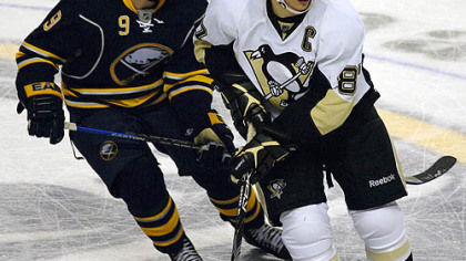 Sidney Crosby, right, waits for a pass as Buffalo Sabres center Derek Roy defends during the third period last night.