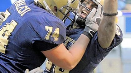 Pitt's LeSean McCoy is congratulated by teammate John Malecki after scoring a touchdown to help get his team within two points of West Virginia in the fourth quarter yesterday.