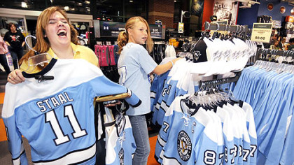 Katelyn Feicht,16, of Shaler, left, and her cousin Haley Nightingale,12, of Collier Township, shop at Dick's Sporting Goods in Robinson for the blue "throwback" Penguins hockey jerseys.