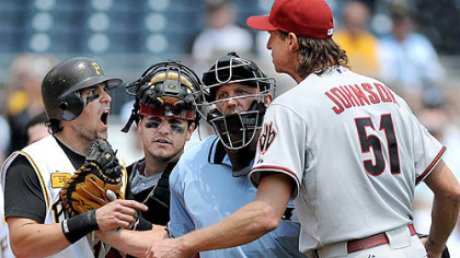Pirates' Doug Mientkiewicz  and Diamondbacks' pitcher Randy Johnson, right are restrained from getting to each other.