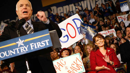 Sen. John McCain addresses a campaign rally in Hershey Tuesday as his running mate, Gov. Sarah Palin applauds.