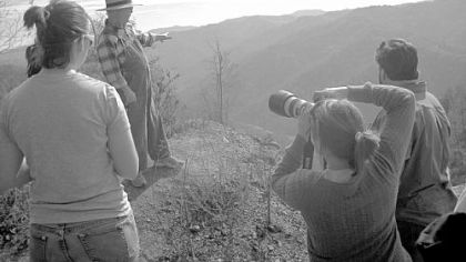 Larry Gibson, who lives on Kayford Mountain, shows what the mountain looked like before mountaintop mining. From left are recent Bryn Mawr graduate Zoe Ruge, Backpacker Magazine Photo Editor Julia Vandenoever and Restoring Eden Executive Director Peter Illyn.