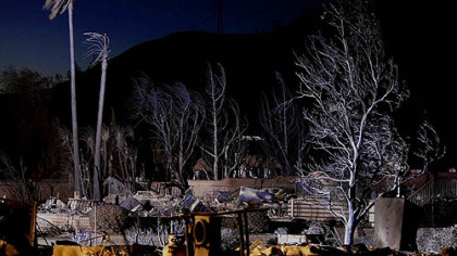SYLMAR, Ca -- The ruins of nearly 500 homes destroyed by the Sylmar Fire are seen at night at the Oakridge mobile home park. The entire park was declared a crime scene and cadaver dogs brought in to search for victims. The fire, also referred to as the Sayre Fire, charred 10,000 acres, burned 630 structures, and injured five firefighters by Sunday.