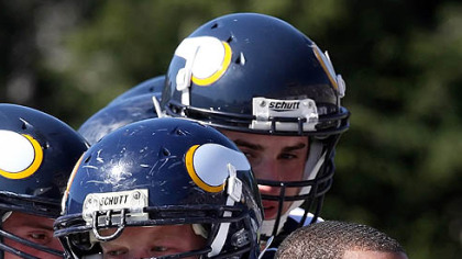 Kyle Wilson (23, right), a Central Catholic football player, died overnight after suffering a stroke while watching a game last Thursday.