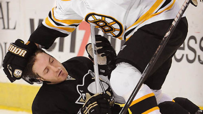 Marc Savard of the Boston Bruins takes down Brooks Orpik in the second period last night at Mellon Arena. The streaking Bruins defeated the Penguins, 5-2.