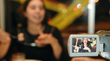 Anjali Sachdeva, 29, of Lawrenceville, eats her waffles as she is videotaped at the Waffle Shop in East Liberty, a project of an undergraduate art class at Carnegie Mellon University.