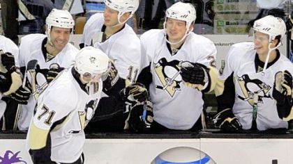 Evgeni Malkin is congratulated by teammates after his goal in the shootout against the Bruins last night in Boston.  The Penguins beat the Bruins, 2-1.