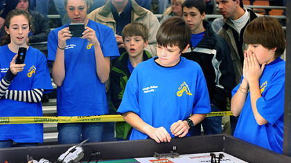 Zolten Glasso, center, and Dominic DiPasquale, right, of the Providence Heights Alpha School 'Alphabots' team from the North Hills, operate the robot at the FIRST LEGO League robot competition as teammates from left, Julia Burgess, Caroline Beauth, John Galbraith and Connor Herbert look on yesterday at Carnegie Mellon University's National Robotics Engineering Center.