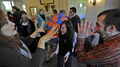 Playback Theater members do fluid exercises at the  Friends Meeting House in Oakland.