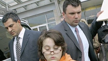Ashley Todd is led from Pittsburgh police headquarters by detectives yesterday.