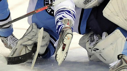 Marc-Andre Fleury gets run over by Toronto's Jason Blake last night.
