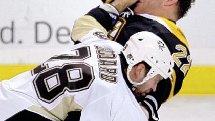 Penguins right winger Eric Godard lands a punch during a fight with the Bruins' Shawn Thorton in the first period last night in Boston.
