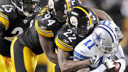William Gay (22), Lawrence Taylor (94) and Ryan Clark gang tackle the Cowboys receiver Roy Williams yesterday at Heinz Field.