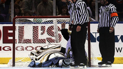 Officials look for -- and find -- the puck beneath the pile of goalie equipment that is Dany Sabourin and determine that he had, in fact, made the save that beat the Islanders.
