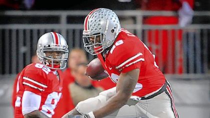 Ohio State running back Chris "Beanie" Wells hurdles Penn State's Drew Astorino last night in the first half.