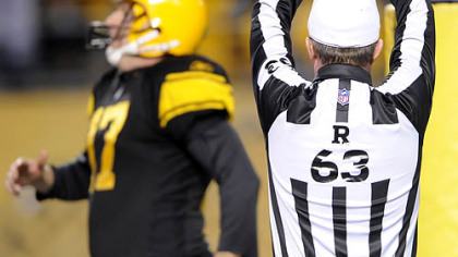 Referee Bill Carollo signals a safety in the fourth quarter. James Harrison, filling in for injured long snapper Greg Warren, snapped the ball over the head of punter Mitch Berger (pictured) and out of the end zone.