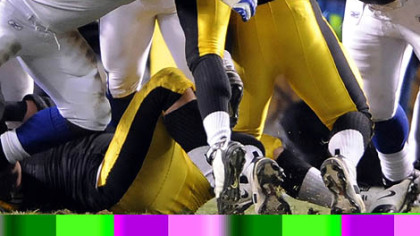 Steelers running back Mewelde Moore is held at the goal line by the Colts' Eric Foster (68) and Antonio Johnson in the fourth quarter yesterday.