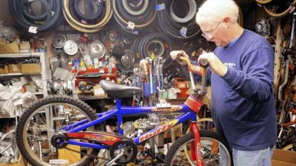 Jerry Kraynick checks out a bike donated for his Bikes for Christmas program Monday in his store, Kraynick's Bike Shop.